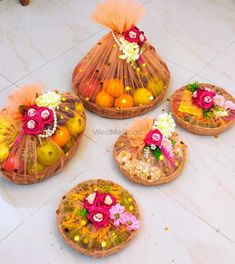 baskets filled with fruit and flowers on the floor