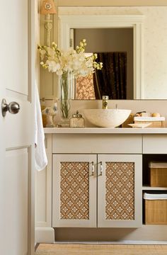 a bathroom with a sink, mirror and cabinet in the corner next to a door