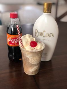 an ice cream sundae next to a bottle of rumchata on a table