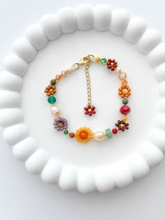 The MARIGOLD beaded bracelet has a bohemian and timeless style. Inspired in the fall season it's the perfect gift for any woman, friend, sister, daughter, etc. 100% handmade using the best materials.  FEATURES:  * Seed beads sizes 2 to 4mm, freshwater pearls 5-7mm, natural stones 4-6mm, and crystals 6-4mm. * 18k Gold Plated Lobster clasp and findings. * Made with love and care. LENGHT: Choose between 6.5 or 7 inches + Each bracelet comes with a 1 inch extender chain CARE INSTRUCTIONS: *Remove be Stone Breslate, Fall Bead Bracelet Ideas, Diy Flower Bracelet With Beads, Handmade Bohemian Bracelets, Diy Christmas Gifts Friends, Handmade Beads Bracelet, Fall Beaded Bracelets, Bracelet Beads Ideas