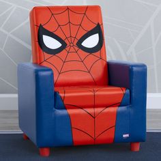 a spiderman chair sitting in front of a wall with the eyes drawn on it