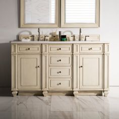 a bathroom with double sinks and two mirrors