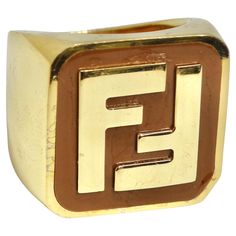 Elevate Your Style with the Fendi FF Logo Gold Tone Ring - A Timeless and Versatile Unisex Accessory! This vintage Fendi ring showcases the unmistakable FF logo in the center. It's a statement piece that reflects the brand's heritage and reputation for luxury. Designed to be versatile and suitable for all, this ring complements any outfit, making it a staple in your jewelry collection. It's the perfect accessory to add a touch of sophistication to any look. Crafted with exquisite attention to de Gold Fendi Ring, Fendi Ring, Bracelet Cartier, Hype Beast, Gucci Loafers, Cartier Bracelet, Ff Logo, Vintage Fendi, Outfit Making