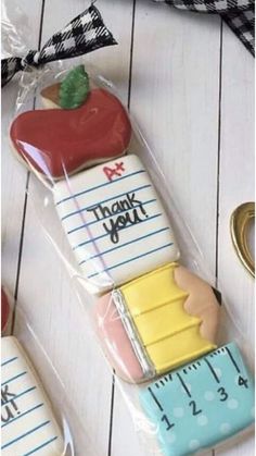 decorated cookies in the shape of an apple and ruler with thank you written on them