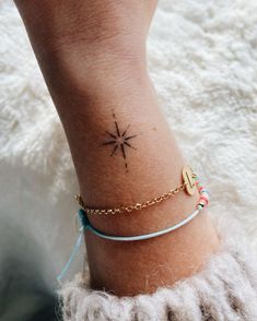 a woman's foot with a small star tattoo on her left ankle and a gold chain bracelet