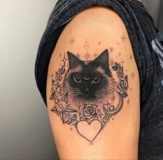 a woman with a cat tattoo on her arm