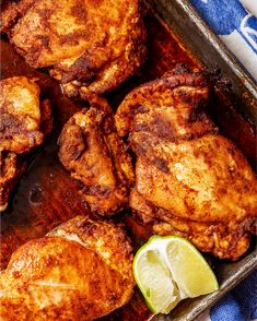 the chicken is ready to be cooked in the oven and garnished with limes