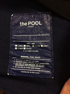 there is a label on the back of a black t - shirt that says, the pool