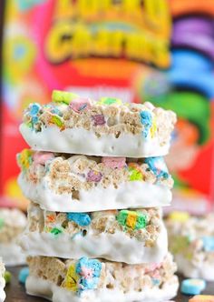 three rice krispy kreme treats stacked on top of each other with cereal scattered around them