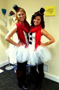 two women dressed in costumes posing for the camera