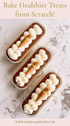 three tins filled with cake sitting on top of a table