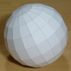 an origami ball sitting on top of a wooden table