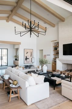 a living room filled with furniture and a flat screen tv mounted to the wall over a fireplace