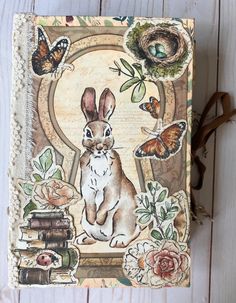 a book with an image of a rabbit and butterflies on the cover, sitting next to a pair of reading glasses