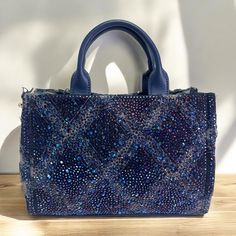 This Rhinestone Handbag Is Stylish Bag Covered In Shiny Rhinestones That Sparkle In The Light. It's Perfect For Special Events Or Nights Out, Adding A Touch Of Glamour To Any Outfit. The Bag Often Has A Simple Design With A Chain Or Handle, Making It Both Elegant And Easy To Carry. Rhinestone Handbags, Bag Cover, Blue Rhinestones, Stylish Bag, Blue And Silver, Simple Design, Special Events, Simple Designs, Night Out