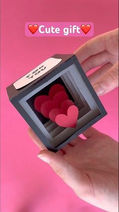 someone is holding a small box with hearts in it and the caption says cute gift