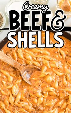 creamy beef and cheese shells in a skillet with a wooden spoon on the side