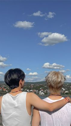 two people are flying a kite in the sky