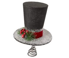 a black top hat with red ribbon and holly berry decoration on the side, surrounded by silver glitter