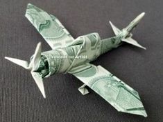 an origami airplane made out of one dollar bill