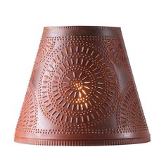 a brown lamp shade with an intricate design on the top and bottom, made out of leather