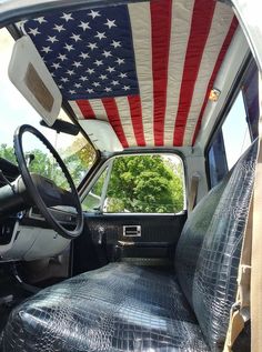 an american flag covering the interior of a truck