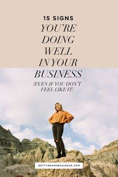 a woman standing on top of a rock with the words 15 signs you're doing well in your business even if you don't feel like it