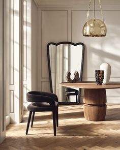 an elegant dining room with wooden floors and white walls