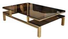 a coffee table with glass top and metal legs