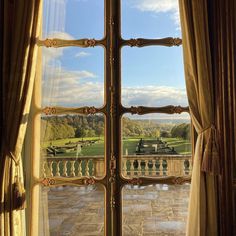 an open window looking out onto a park