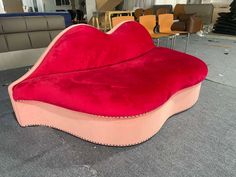 a heart shaped couch sitting on top of a floor