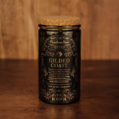 a glass jar sitting on top of a wooden table next to a cork covered lid