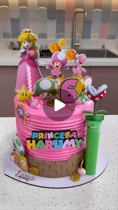 a pink cake with mario and friends on it