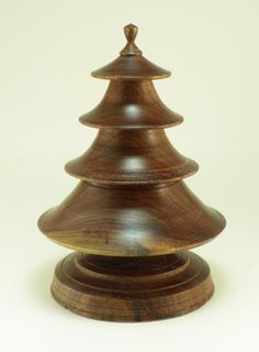 a small wooden christmas tree sitting on top of a table