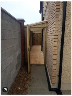 an open door leading into a small room in the side of a brick walled building