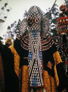 two people dressed in elaborately designed clothing