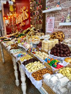 a table filled with lots of different types of donuts and pastries on display