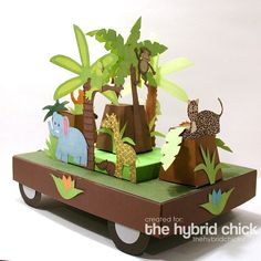 a paper safari scene is displayed on a cart