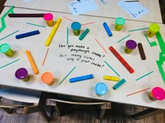 a wooden table topped with lots of different colored items