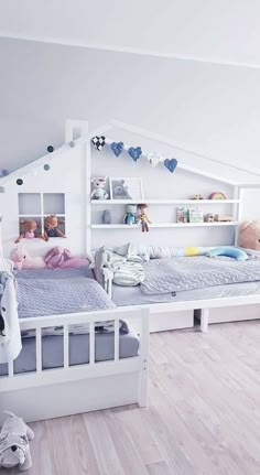 a child's bedroom with white walls and wooden flooring, built into the ceiling