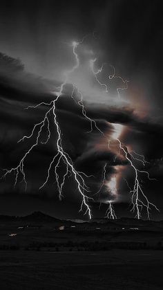 a black and white photo of lightning in the sky