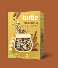 a box of granola with cinnamons and nuts in it on a brown background