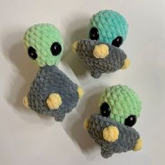 three crocheted stuffed birds sitting on top of each other