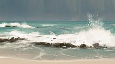 an ocean scene with rocks and water splashing in the foreground, under a cloudy sky