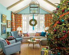 a living room decorated for christmas with blue furniture