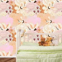 two teddy bears sitting on top of a crib in front of a floral wallpaper