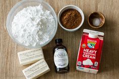 ingredients to make chocolate cake sitting on top of a wooden table next to an empty container