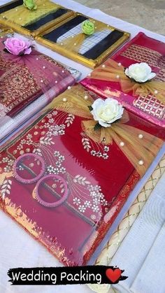 there are many red and gold wedding packages on the table