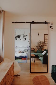 a living room filled with furniture and a large mirror