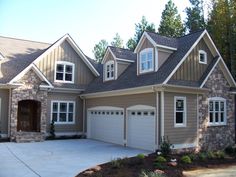 a large house with two car garages in the front